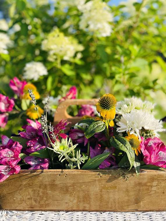 Garden flowers in a wooden trug